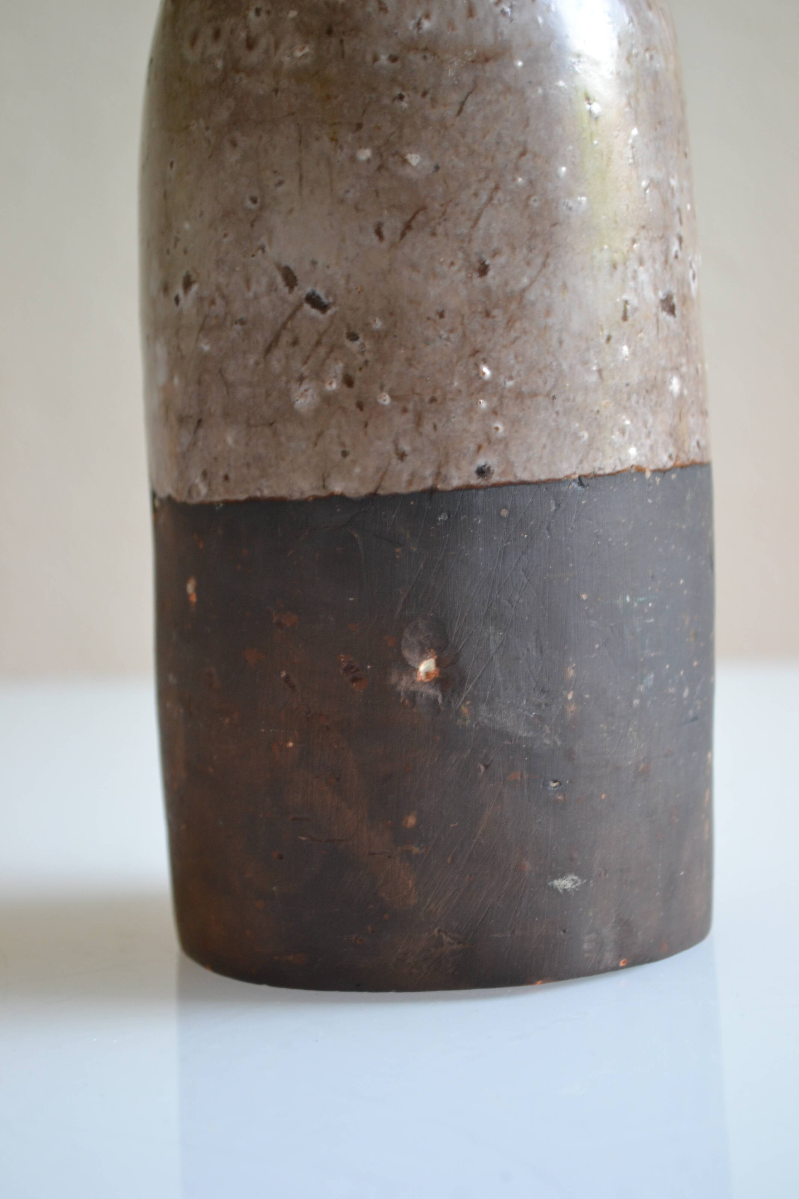Ceramic bottle vase with a fish signature to be identified.