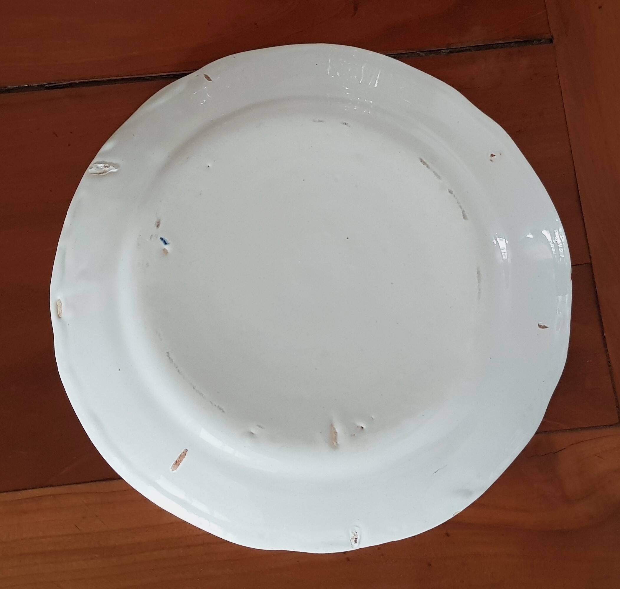 Old round earthenware dish from the East, floral motif