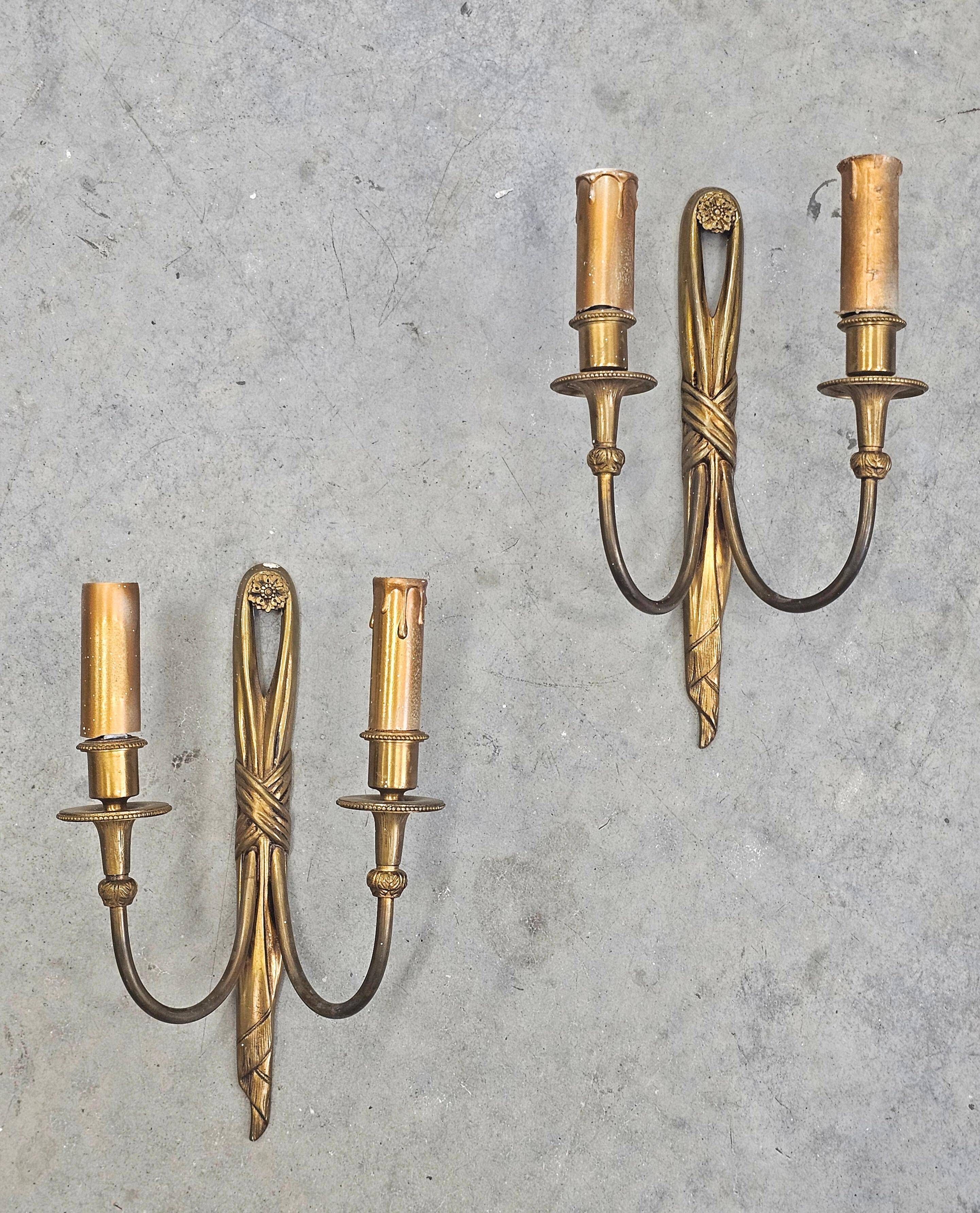 Pair of Louis XVI style bronze wall sconces with bow and tassel, 1940s.