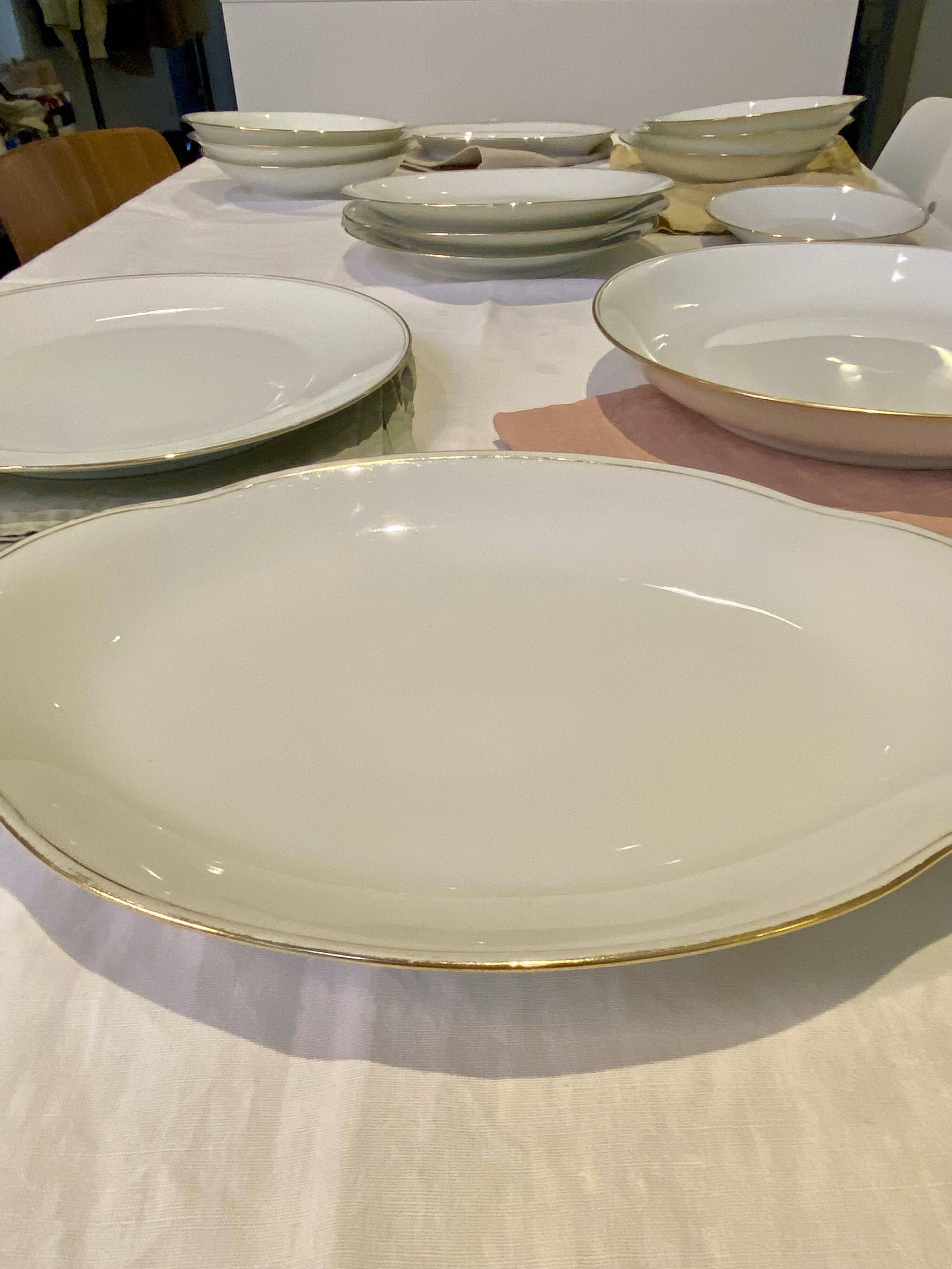 Vintage table service Limoges porcelain white with gold trim.