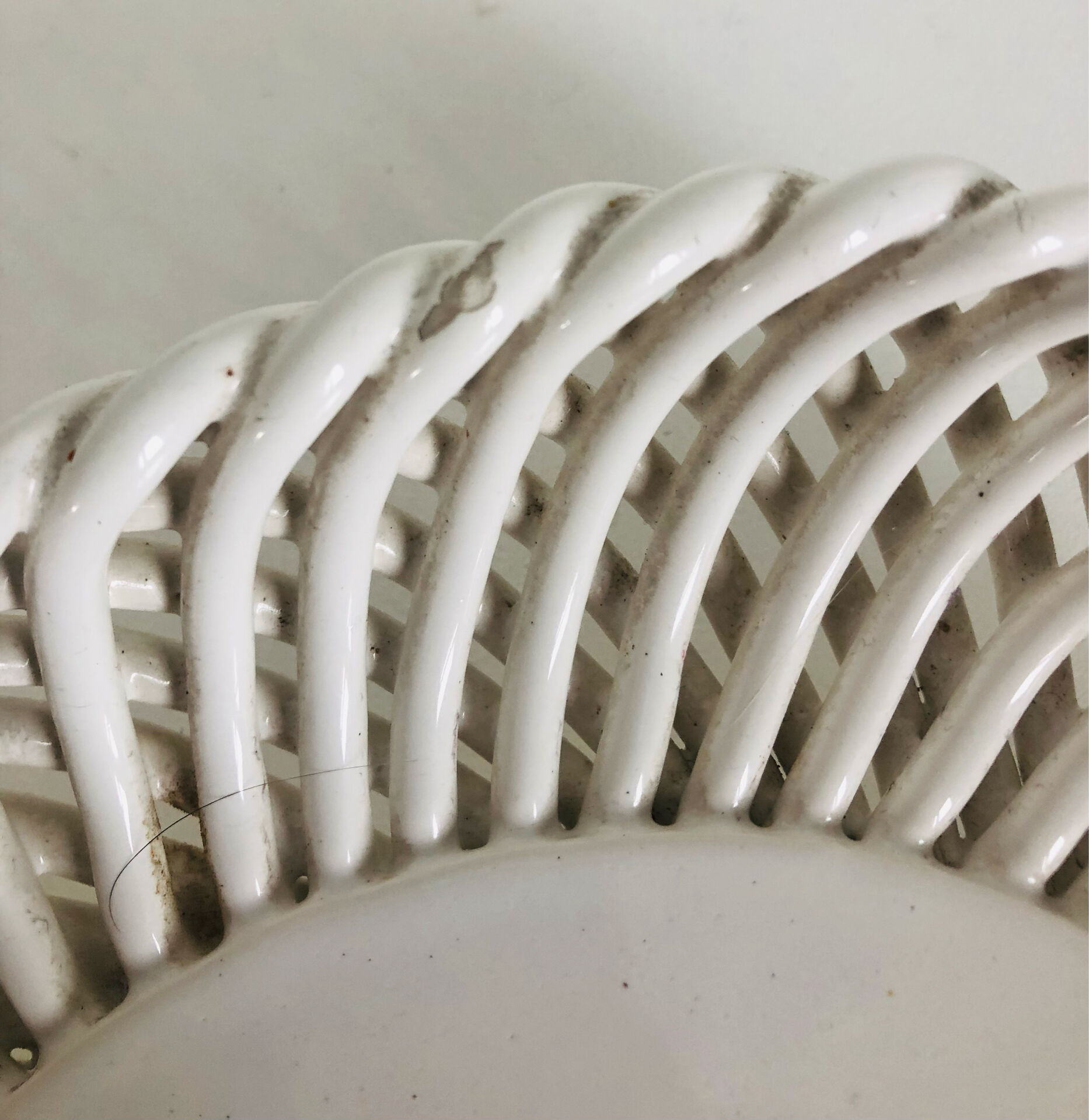 Covered basket in white woven ceramic and fruit slip.