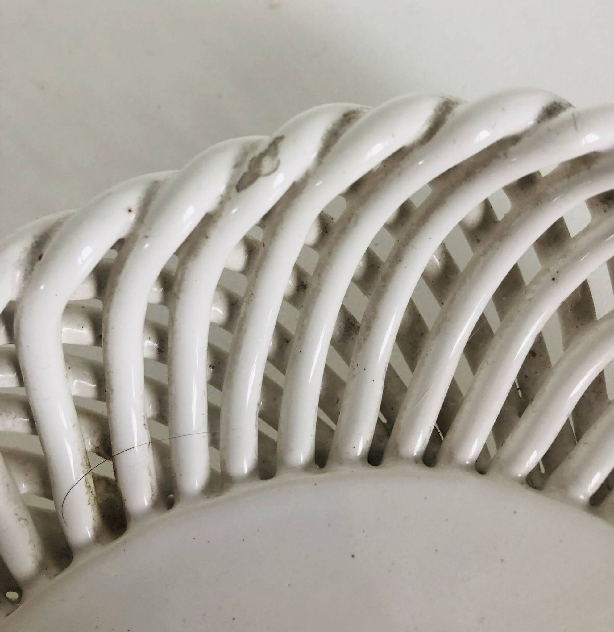 Covered basket in white woven ceramic and fruit slip.