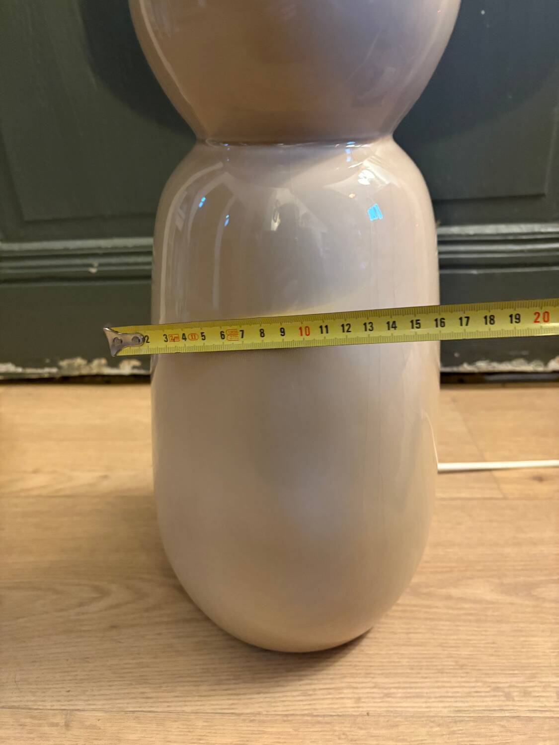 Large beige ceramic table lamp with a vintage shade.