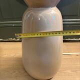 Large beige ceramic table lamp with a vintage shade.