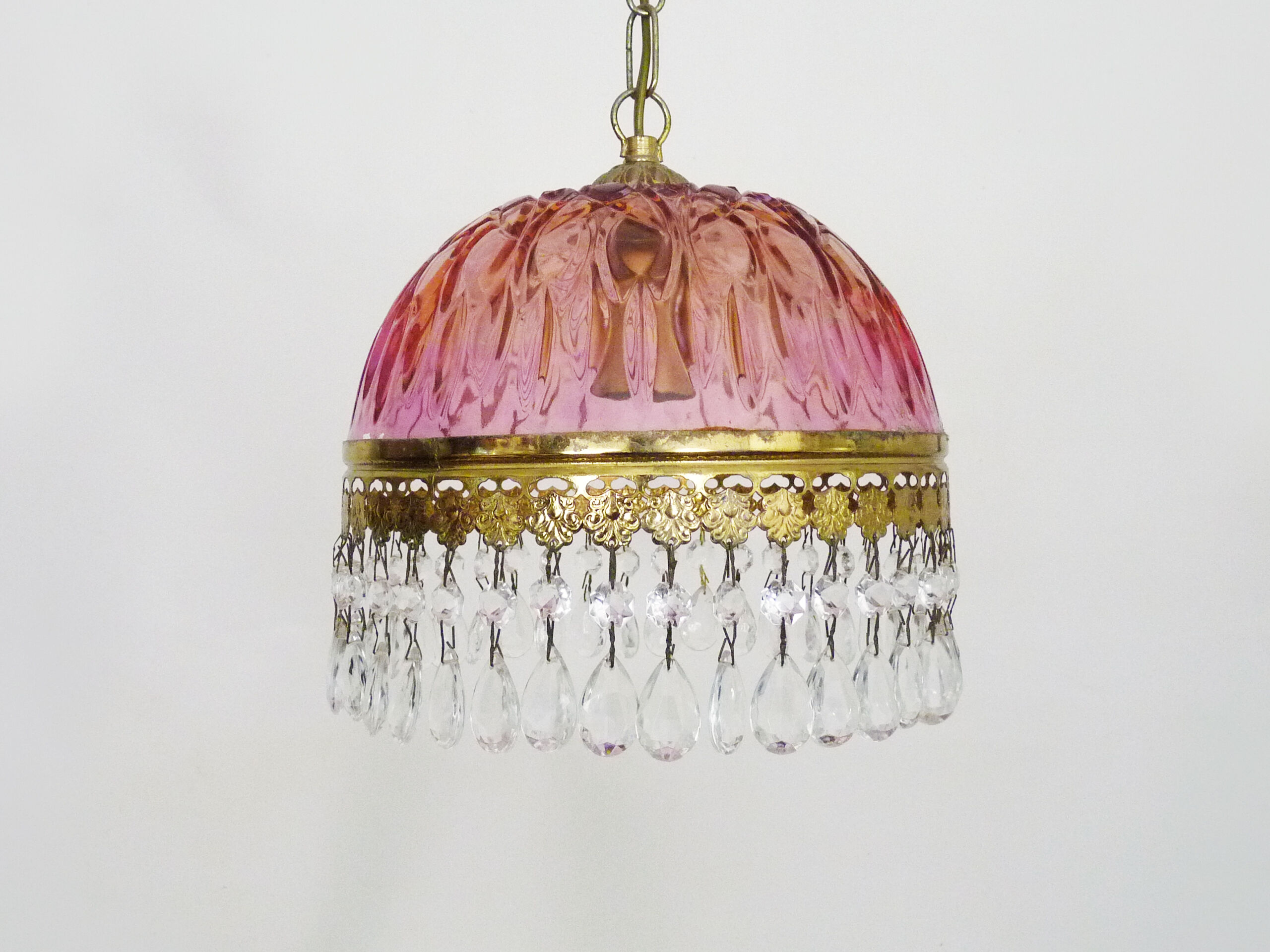 Vintage rose pendant light with pendants and patterned glass globe.