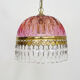 Vintage rose pendant light with pendants and patterned glass globe.