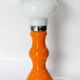 Table lamp or bedside lamp from the 1960s-70s in orange and chrome.