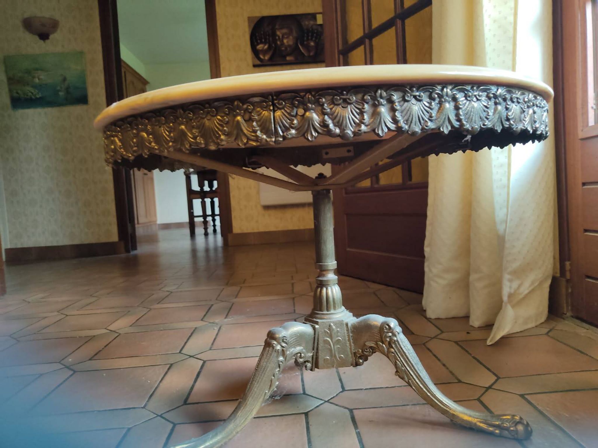 Round coffee table with a brass frame.