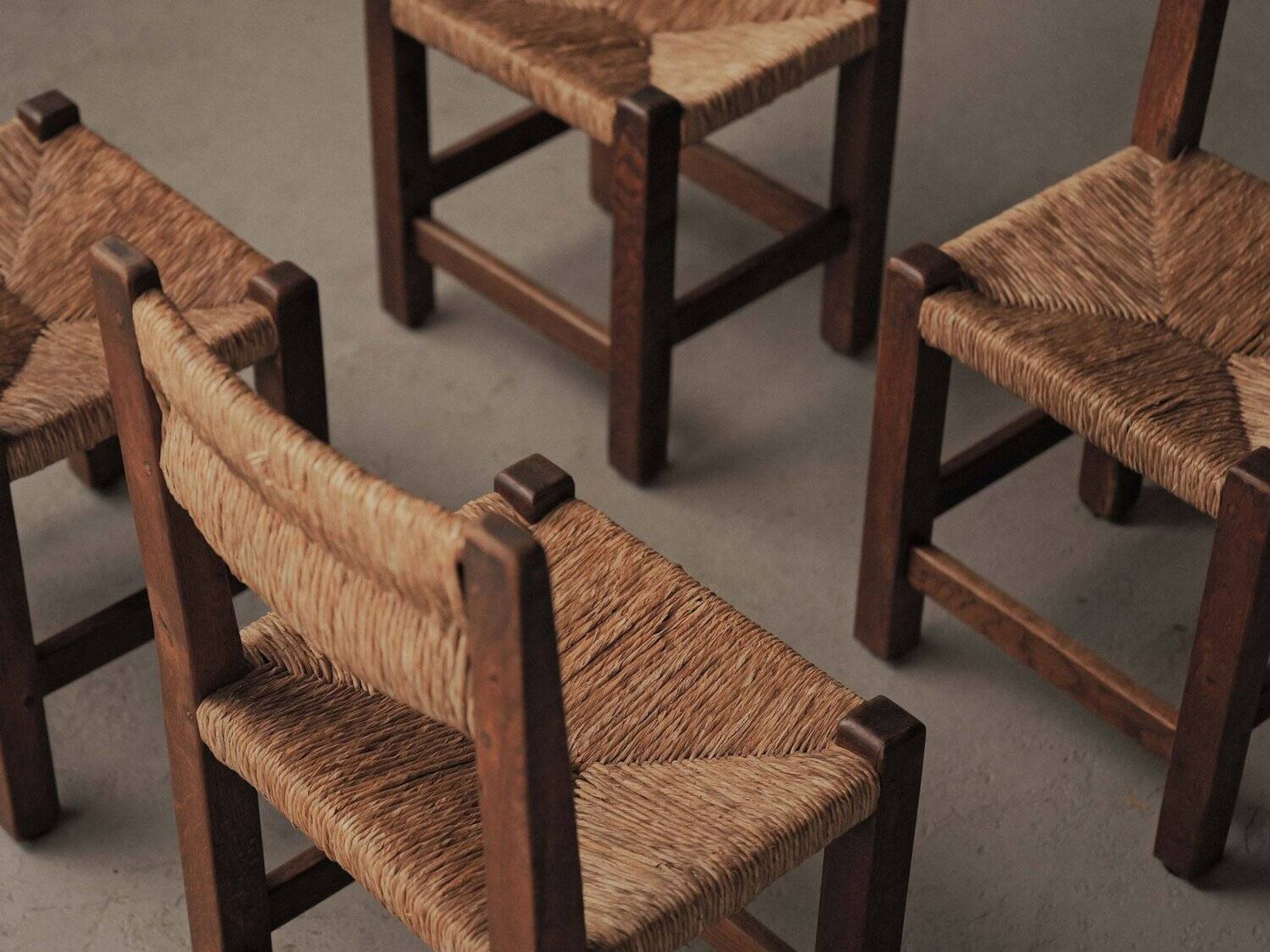 Set of four modernist chairs in oak and straw, France, circa 1960.