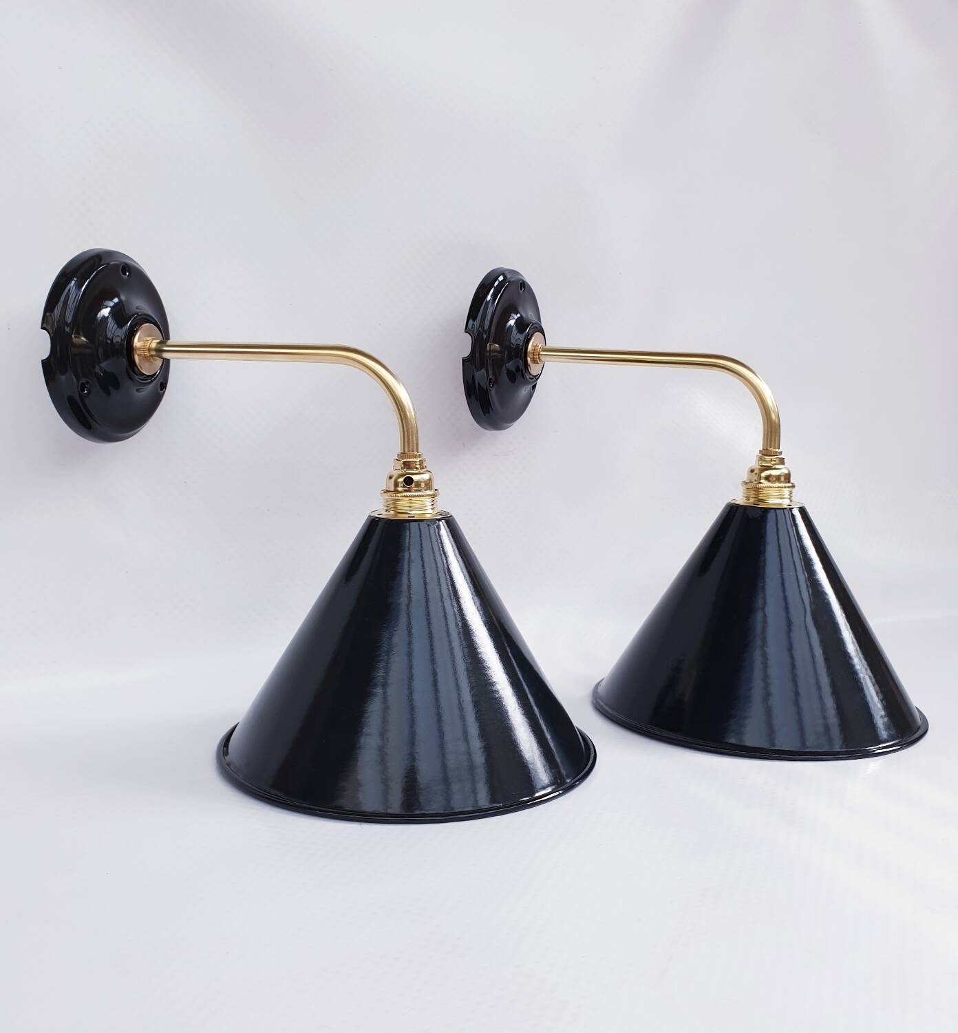 Pair of antique black enamelled sheet metal wall lights