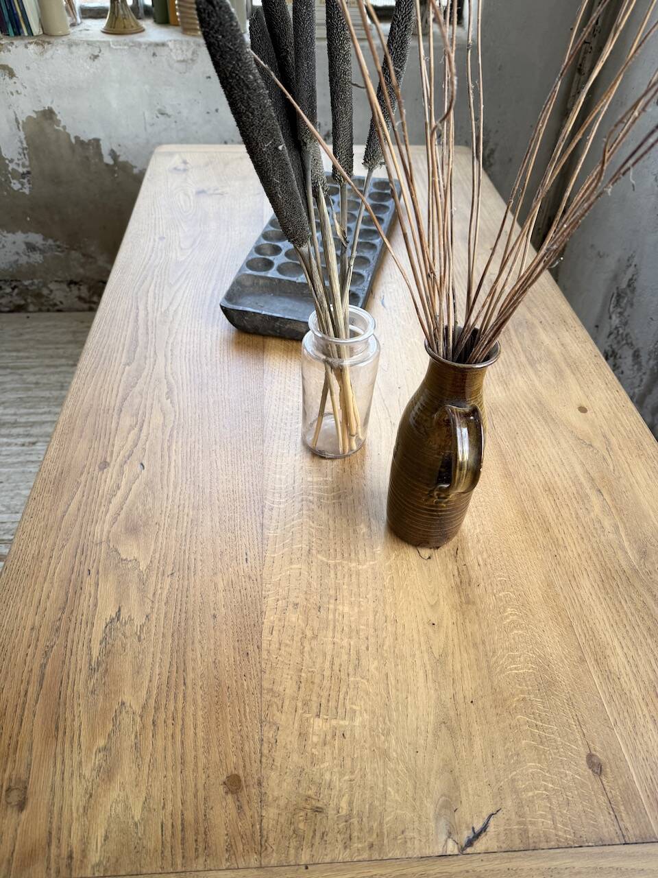 Oak farmhouse table with turned black legs.