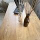 Oak farmhouse table with turned black legs.