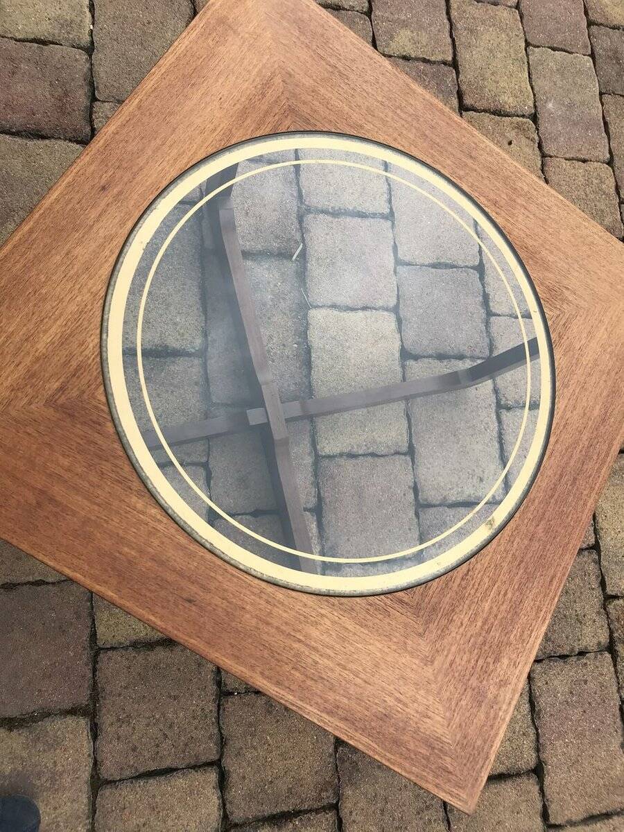 Round glass coffee table with a gold border and brown teak structure, Astro 1960s style.