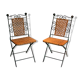 Paire de chaises pliables en fer forgé et rotin.