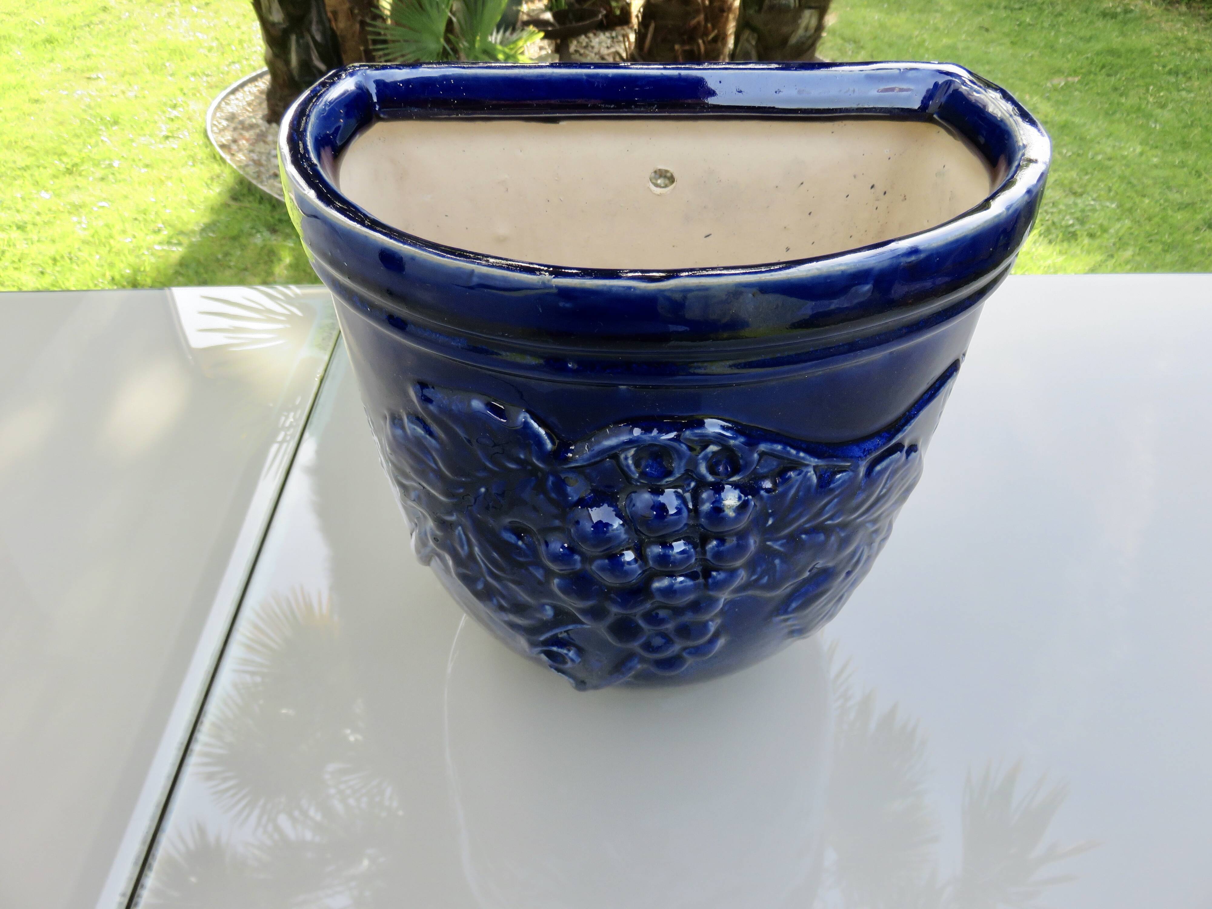 Wall pot in glazed blue terracotta with a grape motif, 1970s.