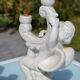 Pair of "cherub" candle holders in plaster