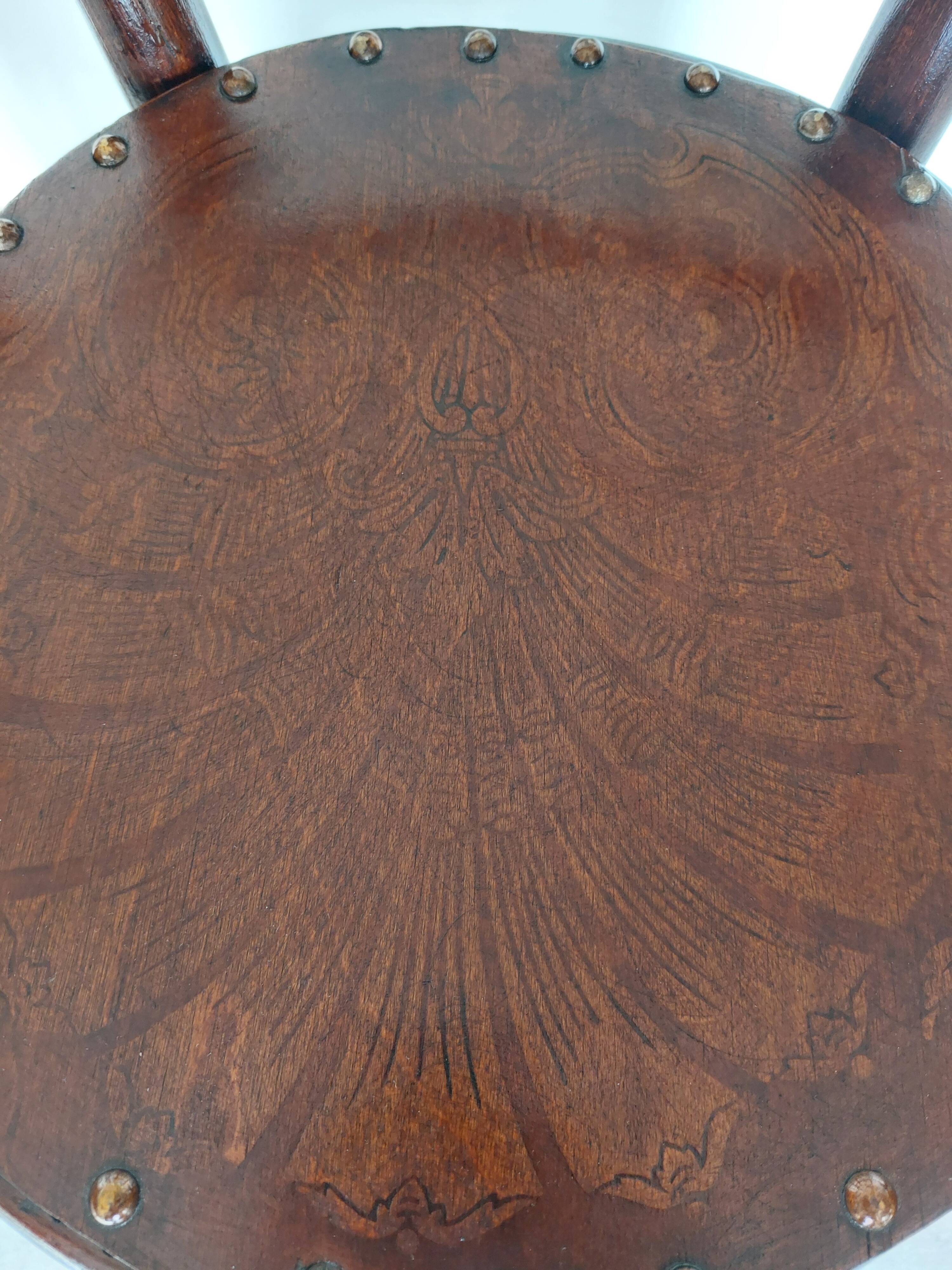 pair of round bistro chairs with a pattern on the seat, vintage