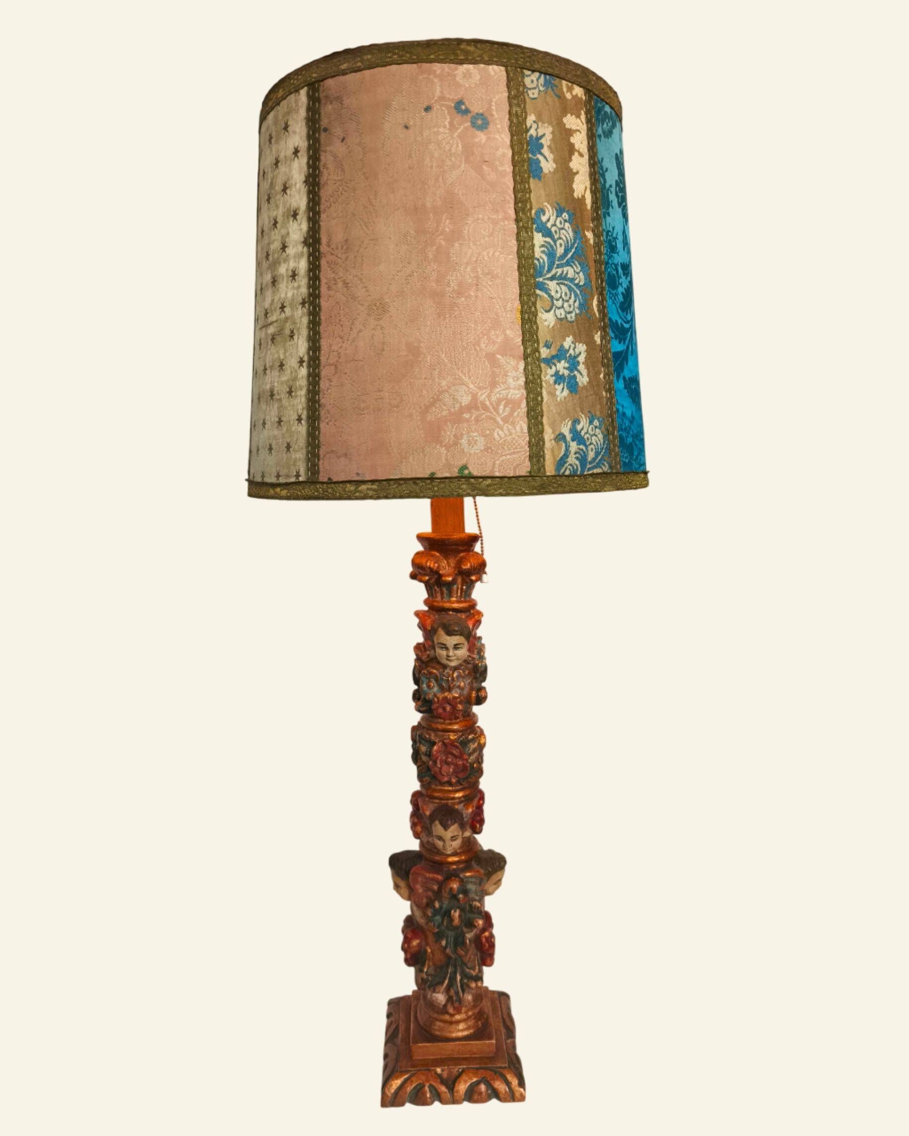 Renaissance table lamp in polychrome carved wood with cherubs.
