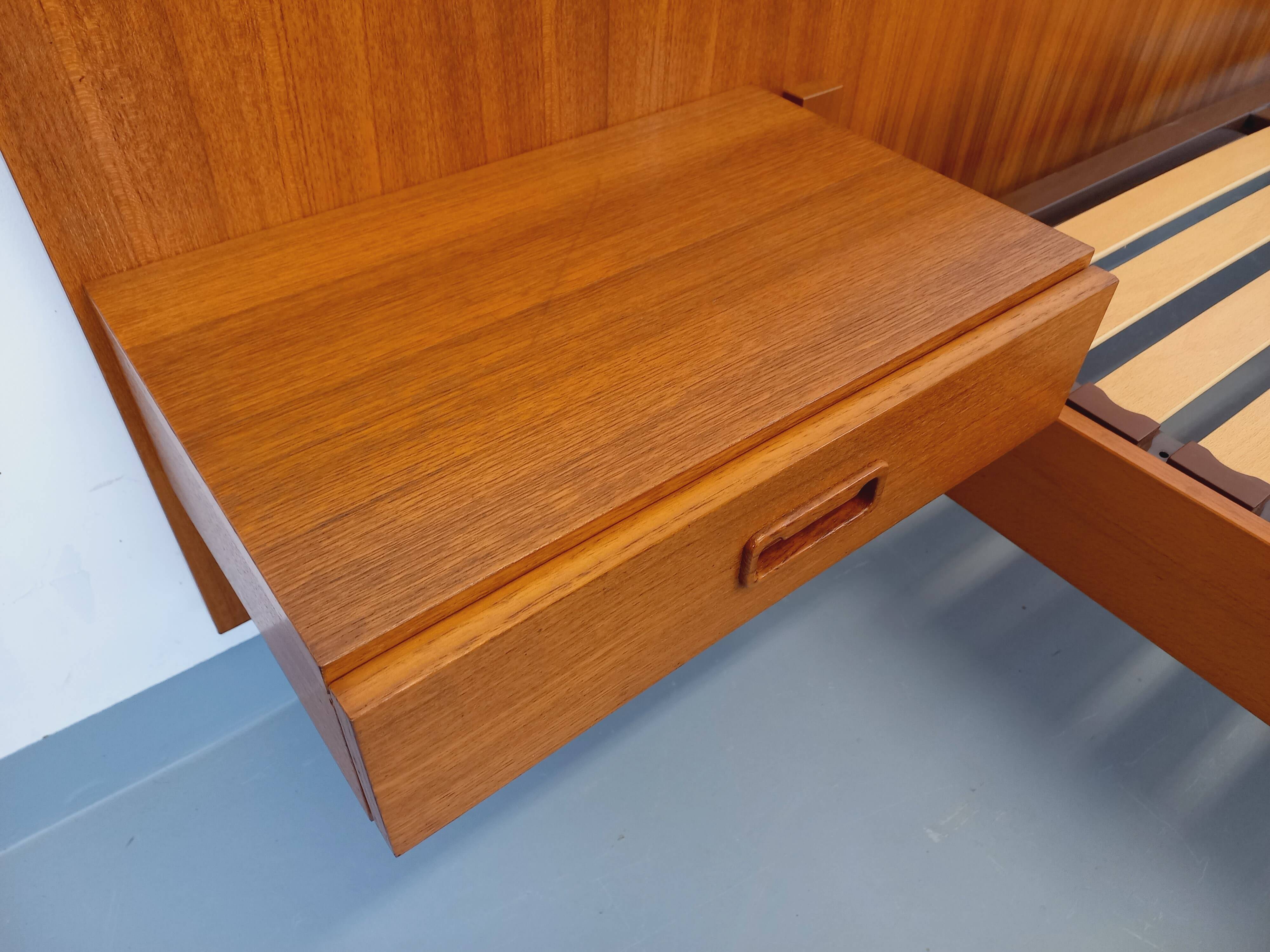 Double bed vintage Scandinavian in teak from the 1960s with integrated bedside tables.