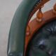 Dark green leather Chesterfield office chair on wheels.
