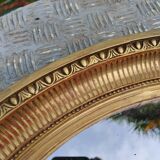 Antique oval mirror in gilded stucco with gold leaf, 19th century