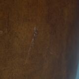 Cognac-colored sheepskin armchair with black piping and decorative nails