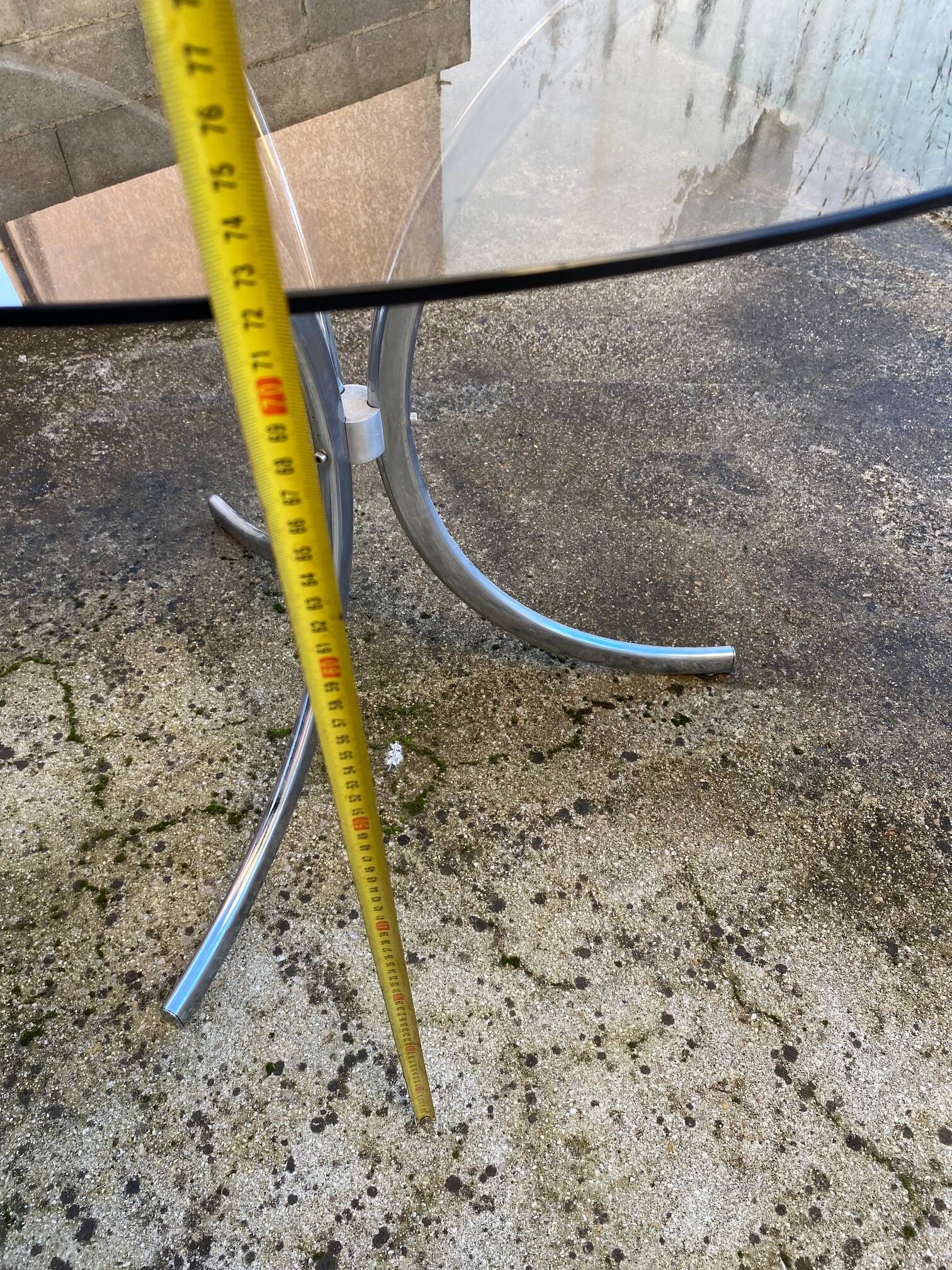 Table with chrome metal legs and smoked glass top.