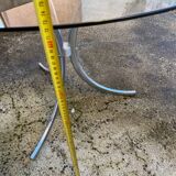 Table with chrome metal legs and smoked glass top.
