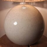 Ceramic lamp with rattan lampshade.