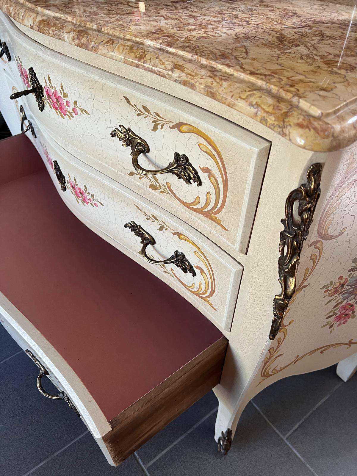 Curved Louis XV style commode in marble with painted floral decoration.