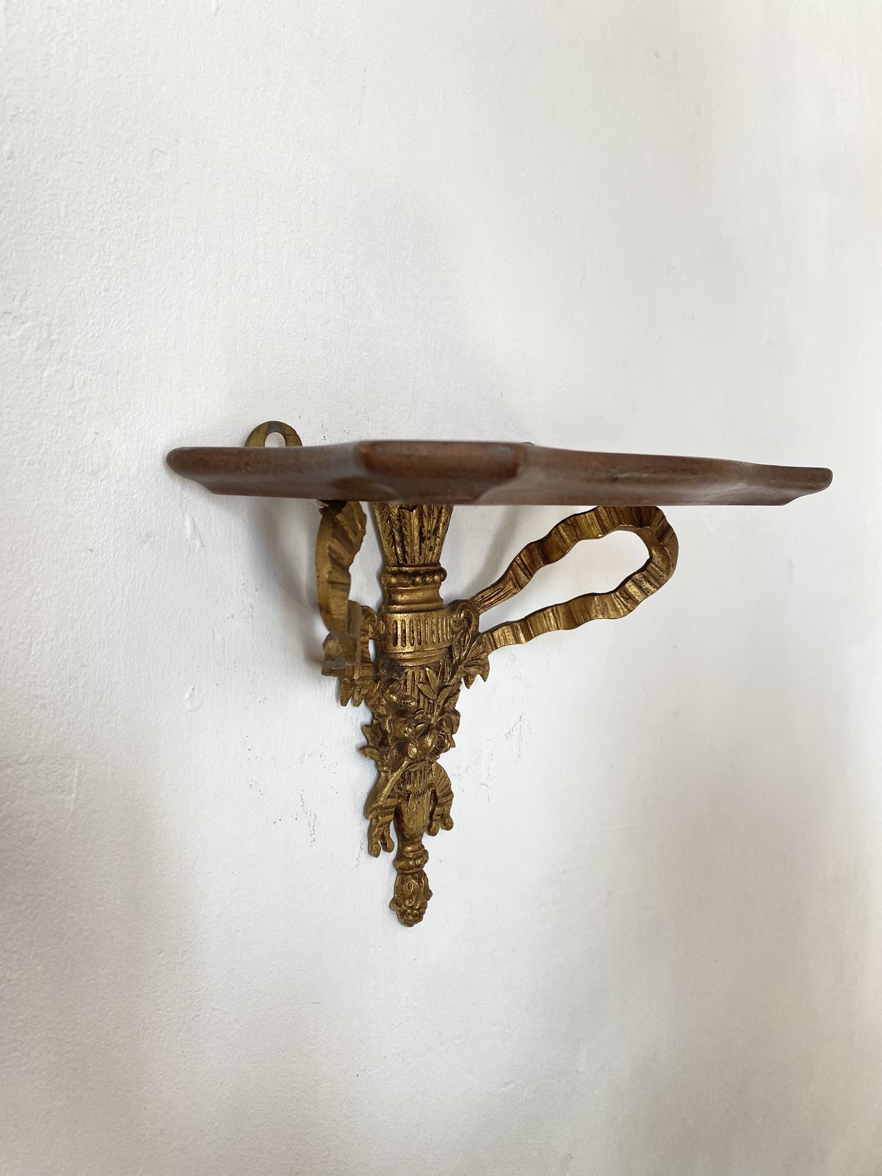 baroque shelf in wood and bronze ribbon