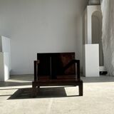 Small low armchair in varnished brown wood
