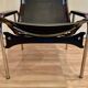 Reclining armchair in black leather and chrome design "hans eichenberger" 1960.