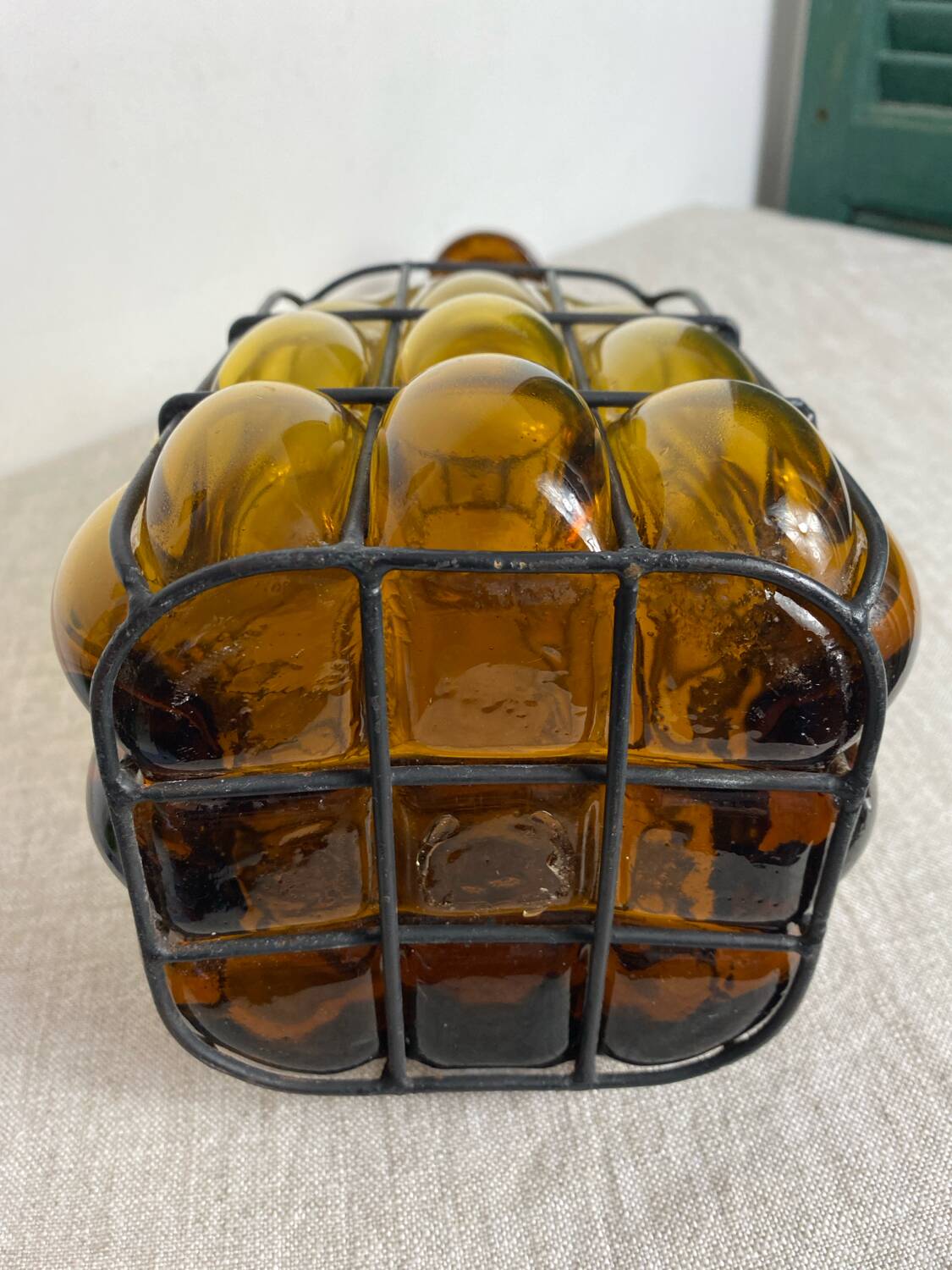 Glass carafe encased in wrought iron