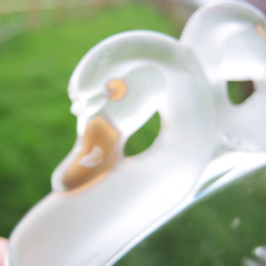 Vintage glass cake stand with swan decoration.