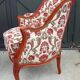 Antique salon with a banquette and Louis XV style bergère chairs.