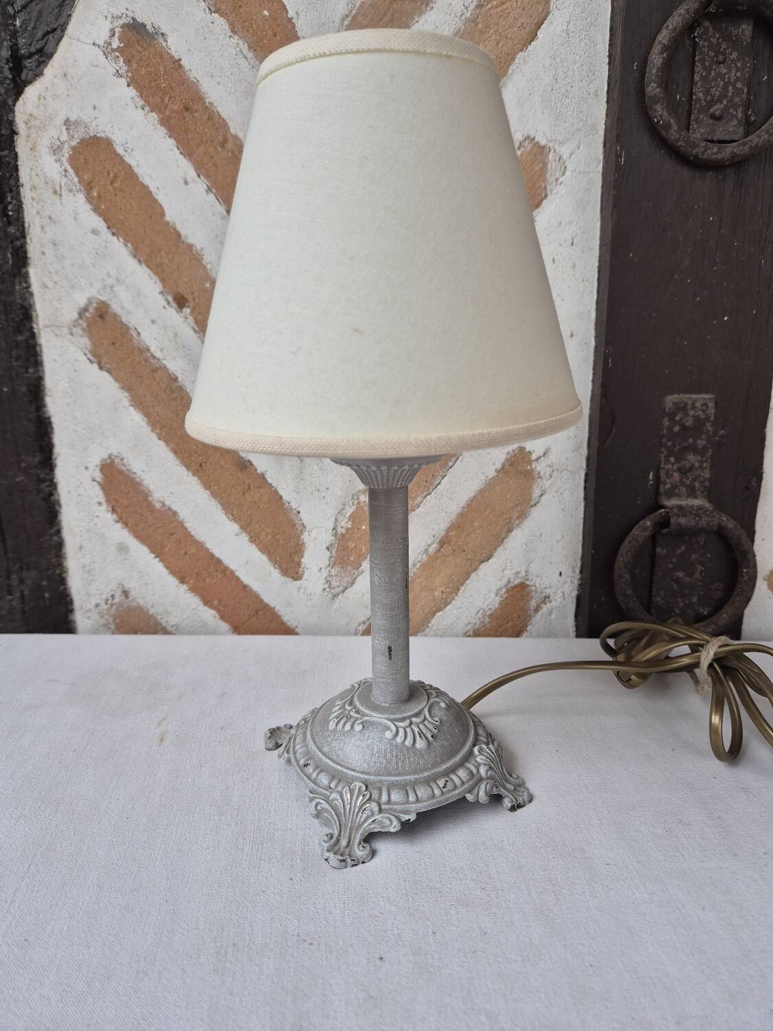 Patinated taupe bedside lamp