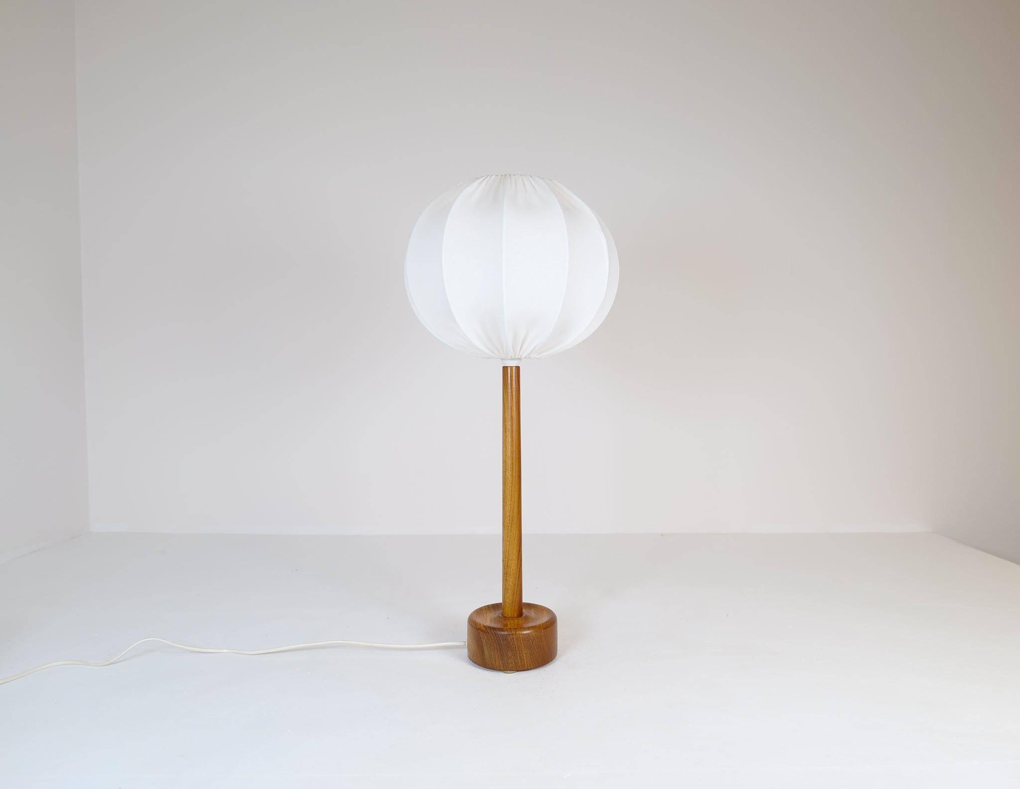 Mid-century solid teak table lamp from the 1960s Sweden.
