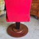Old cinema chair with a red reclining seat.