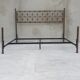 Double bed in burnished brass