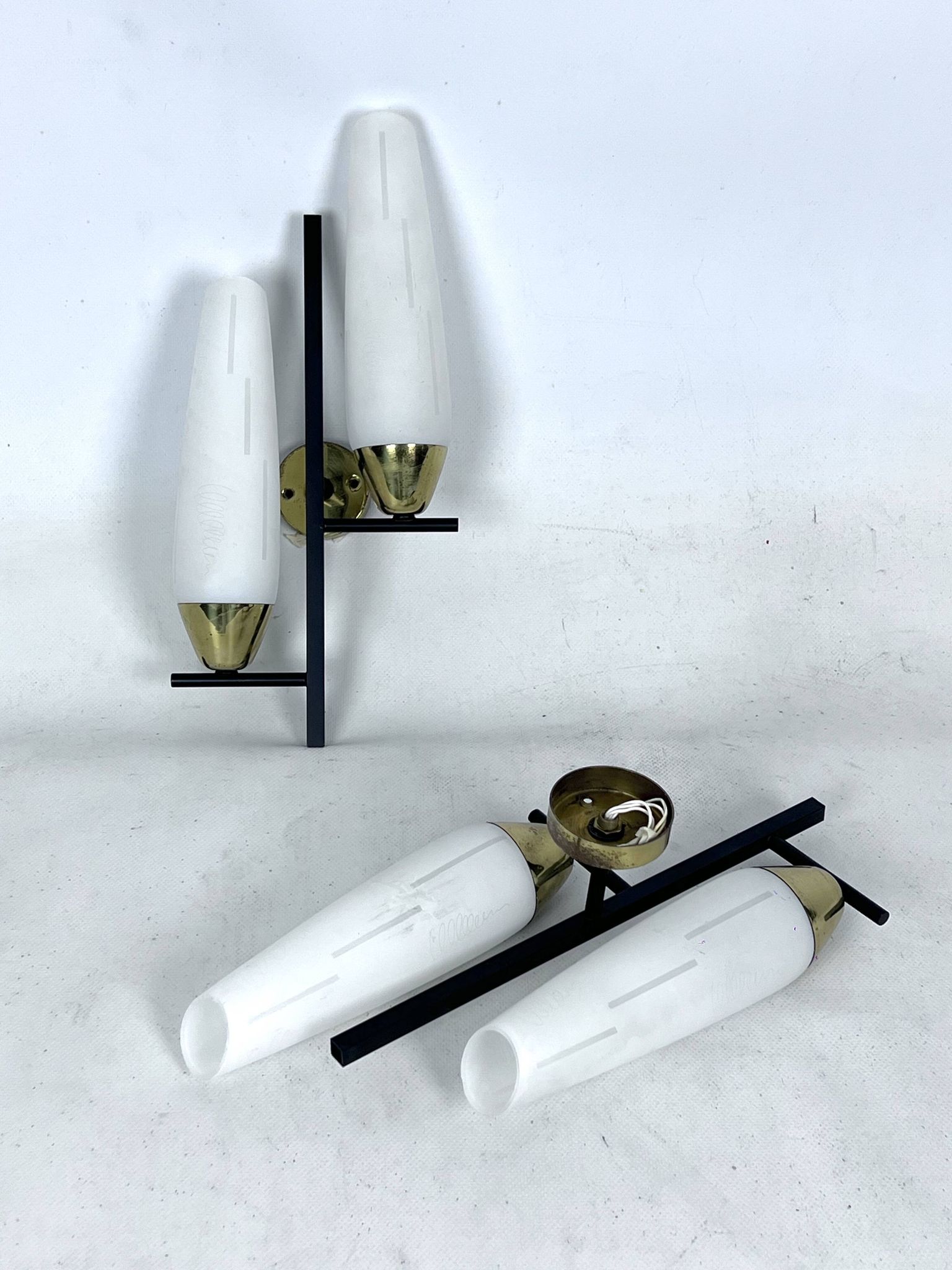 Mid-Century pair of double lights sconces in brass and opaline glass. Italy 1950s