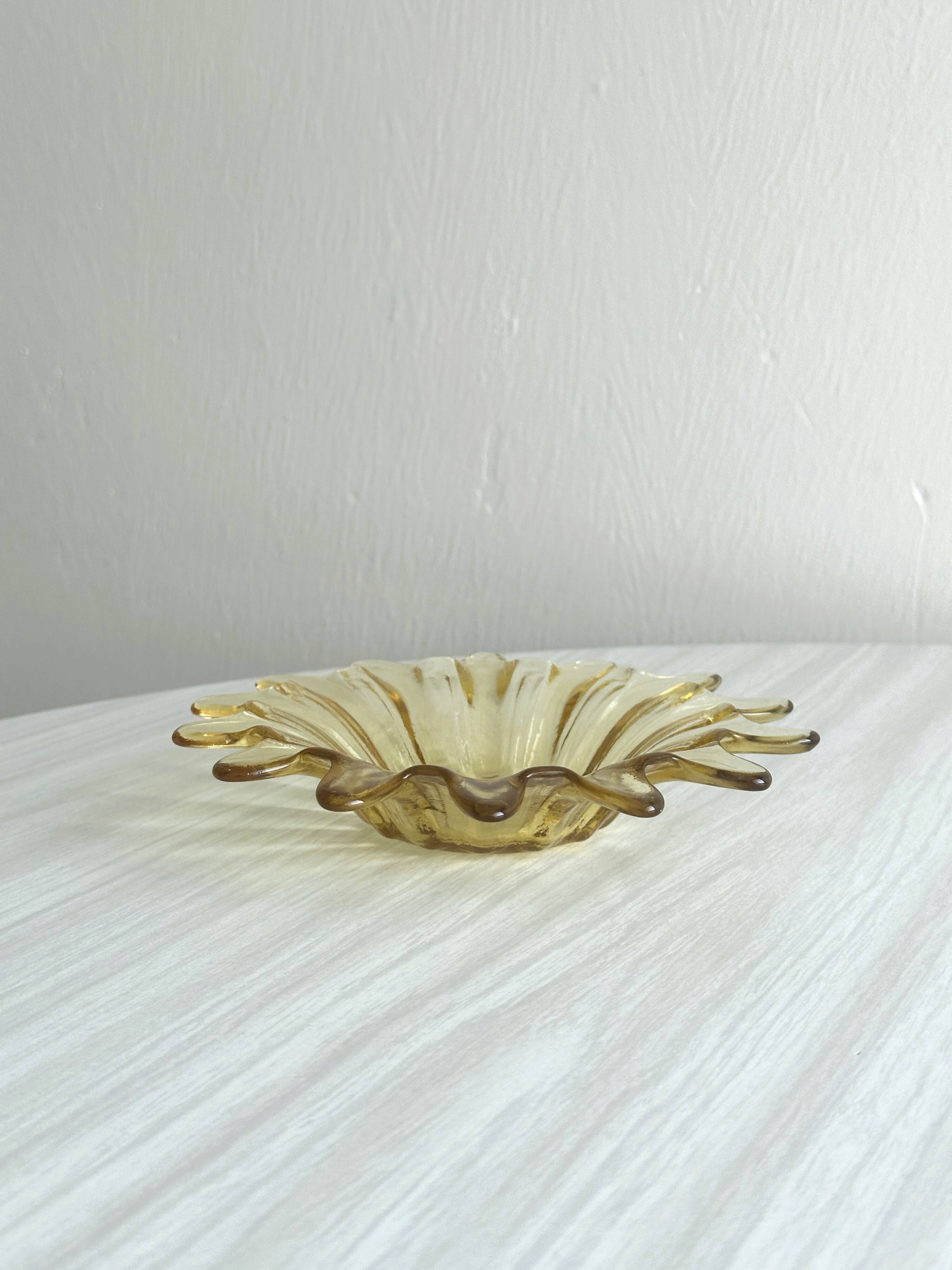 Empty pocket in yellow translucent blown glass, ashtray.