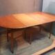 Drop-leaf table with 6 legs and 3 extensions.