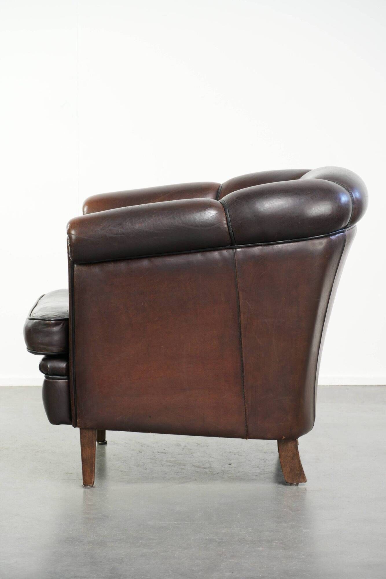 Set of a sheepskin sofa together with its matching club armchair