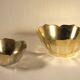 Two brass trundle cups