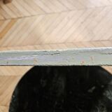 Old mirror with light green contours with mauve shades