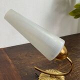 Gold metal wall light with ribbed glass.