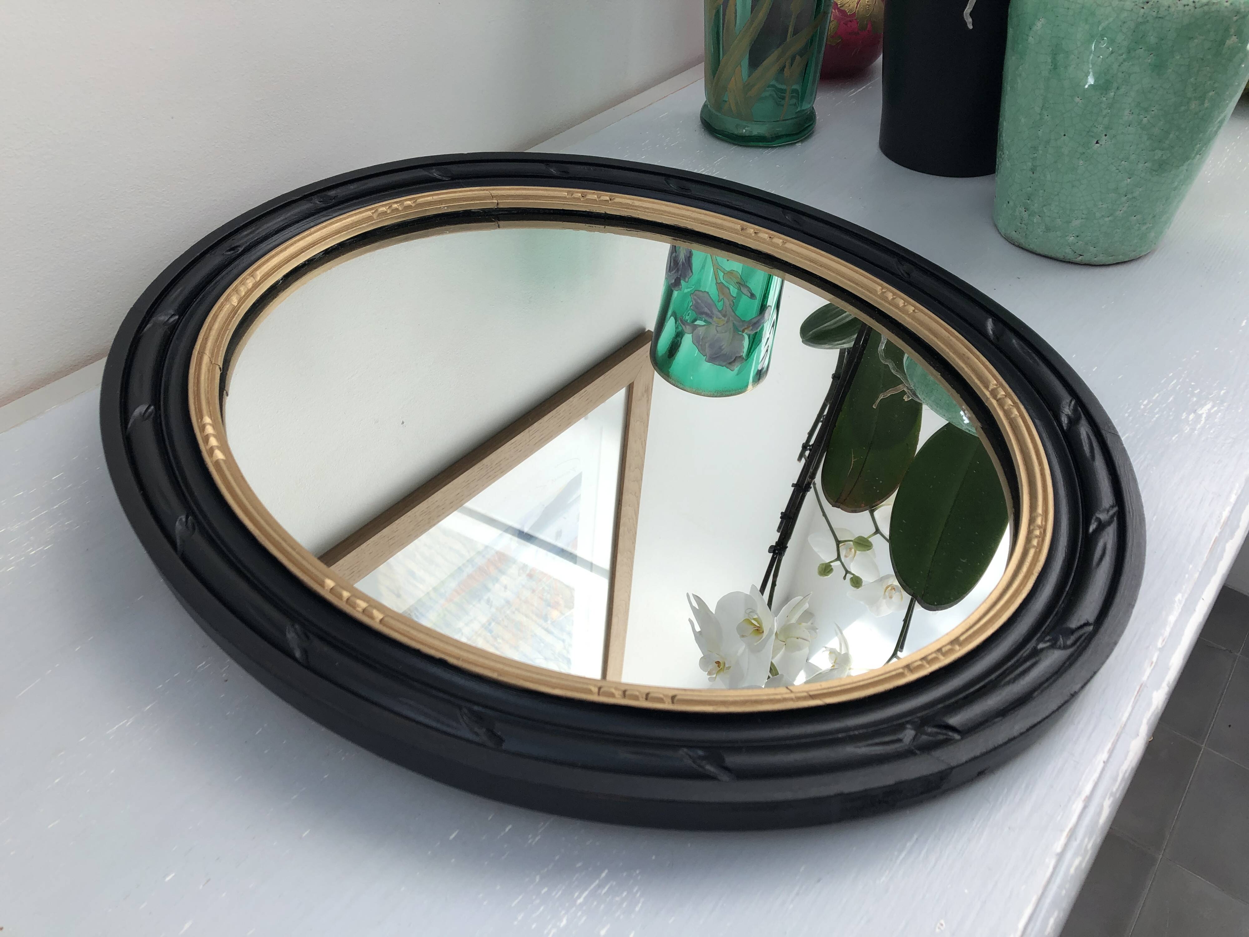 black and gold oval mirror