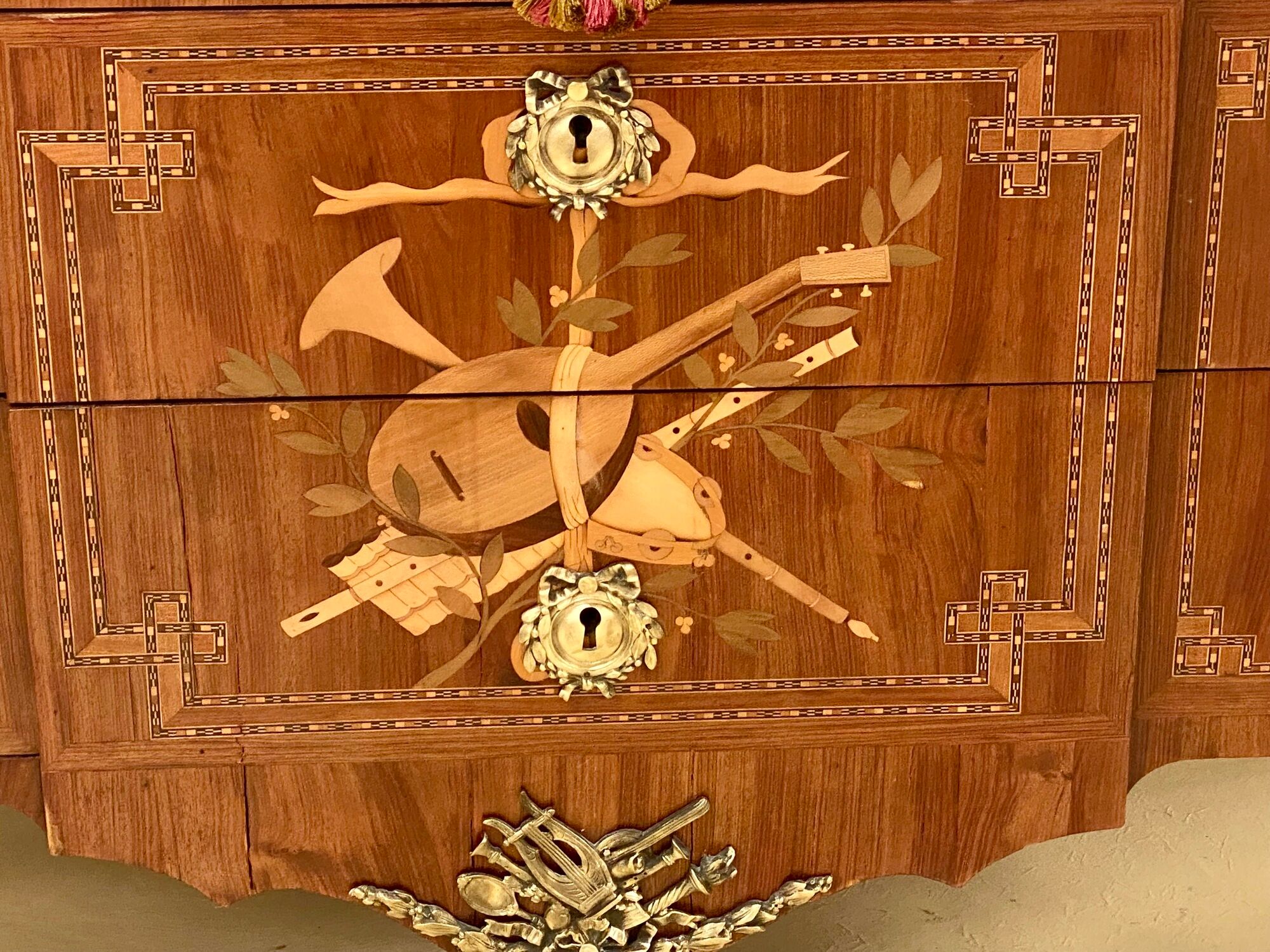 Transition chest of drawers with floral marquetry and music trophy