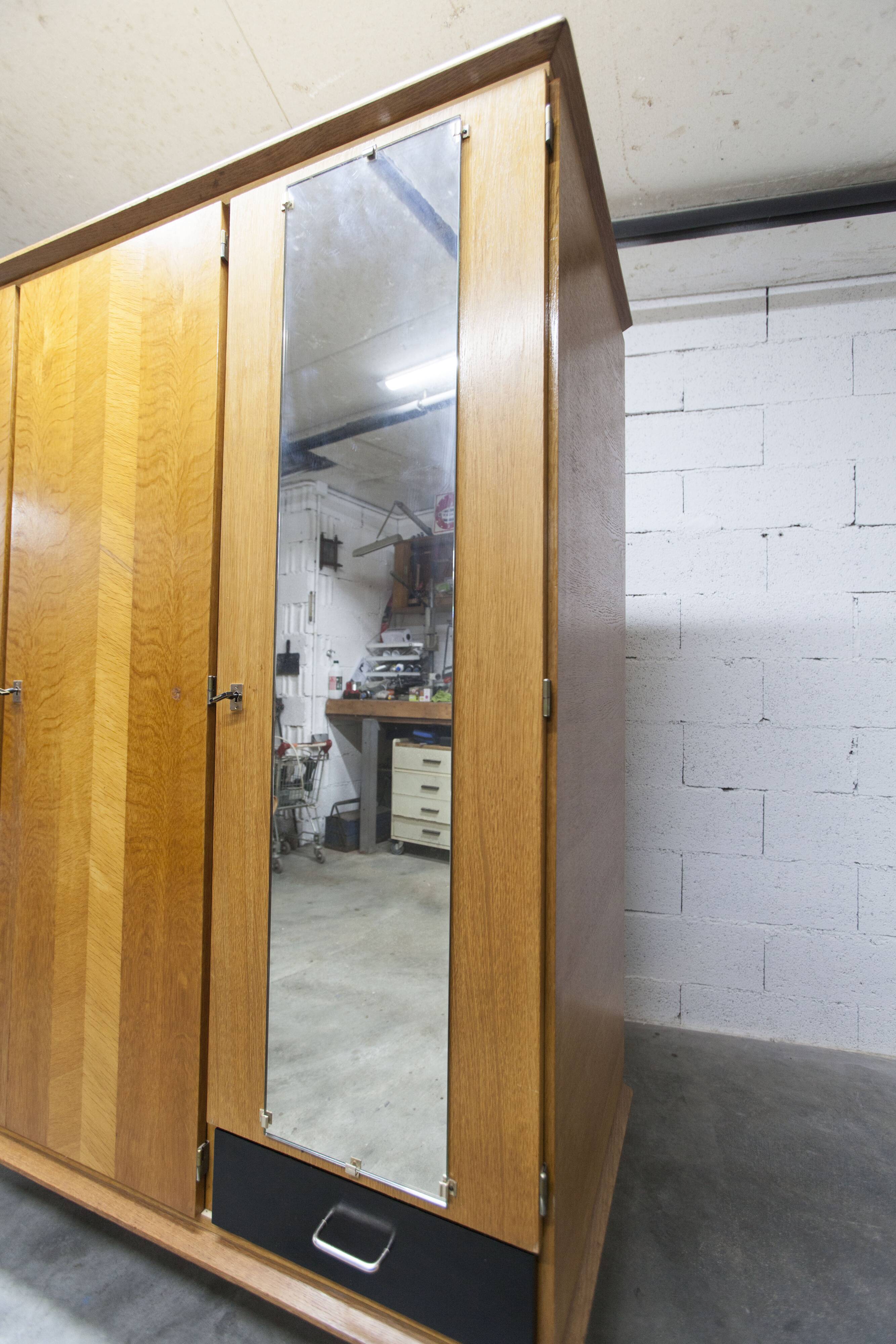 French wardrobe with tapered legs, 3 doors, 1 mirror (27*130), and 1 drawer.